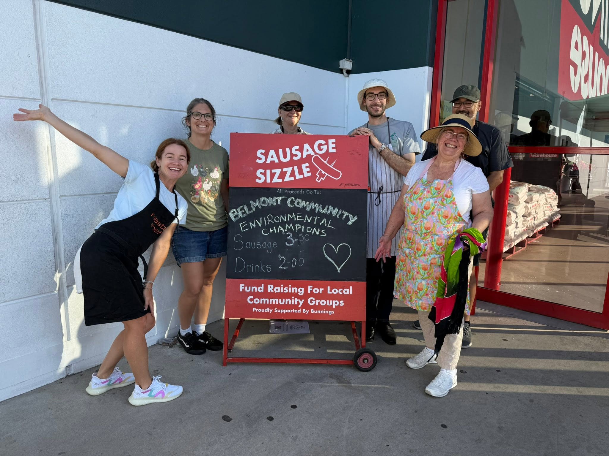 BCEC volunteers beside the Bunnings sausage sizzle sign at Bunnings Belmont
