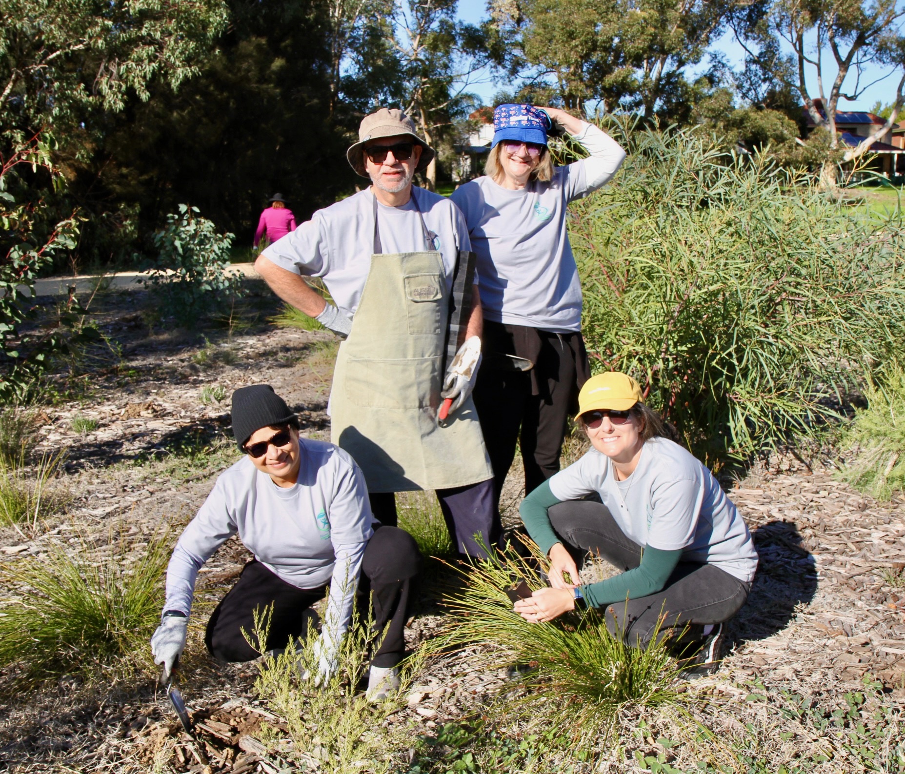 Volunteers and young participants planting together at Garvey Park