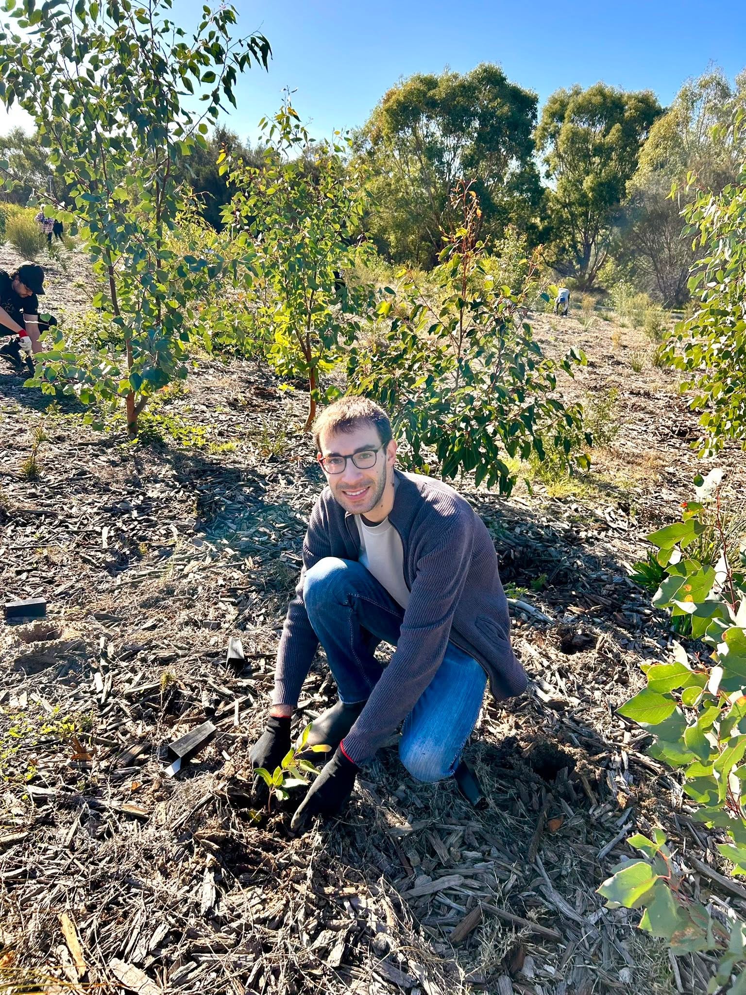Chris planting native seedlings during the green-up
