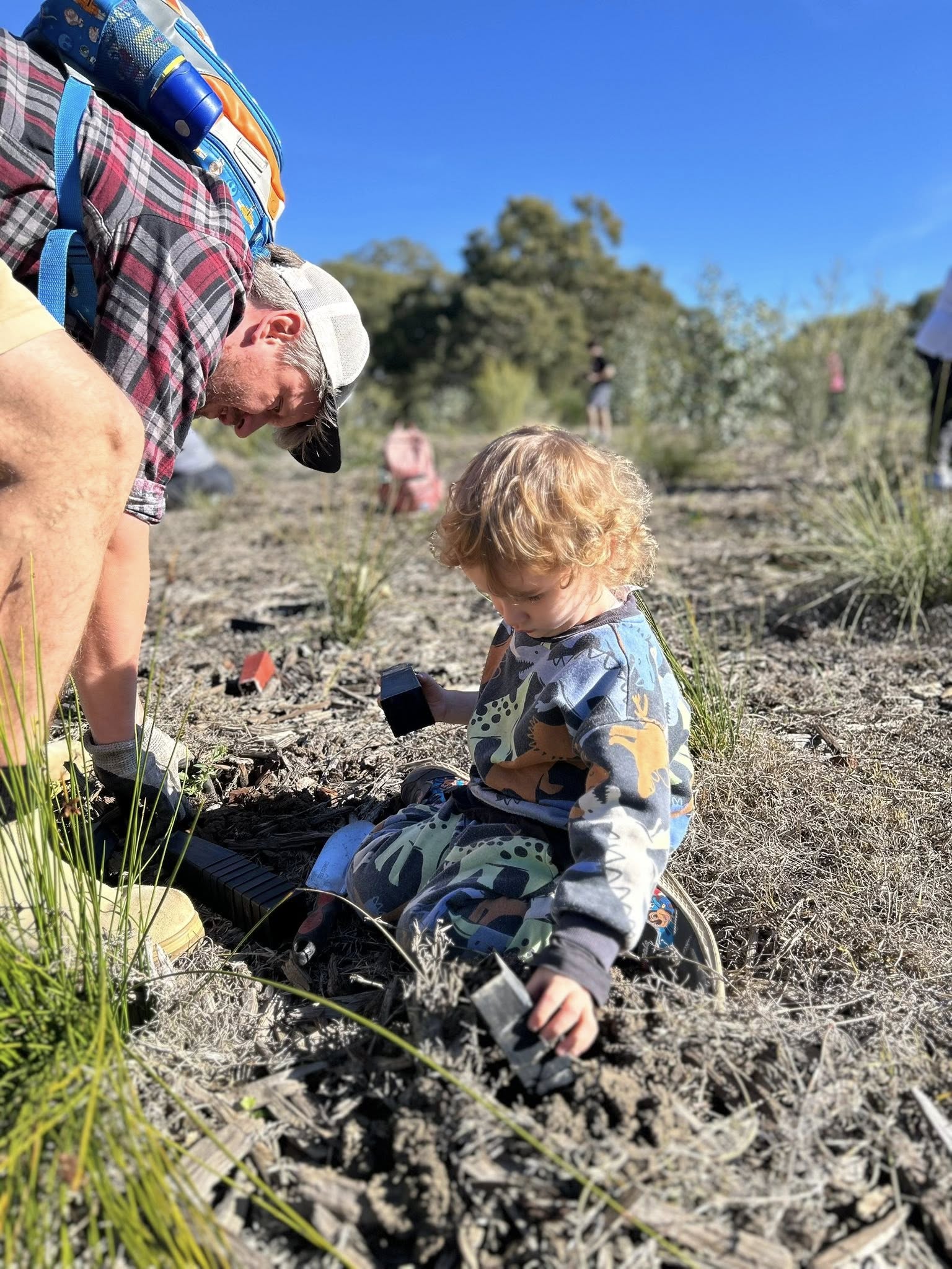 Volunteers planting as part of the Less Mess program activities