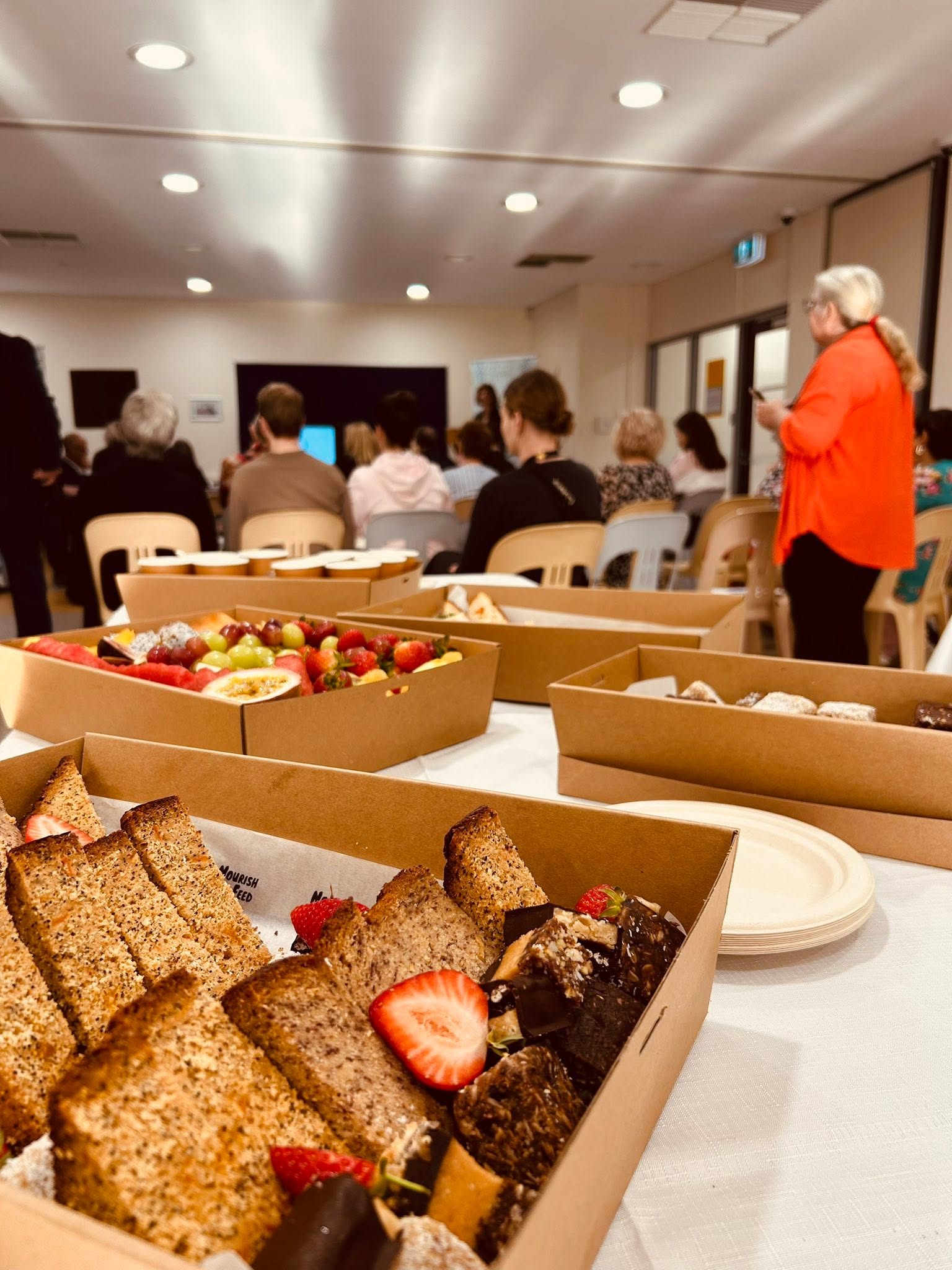 Community members gathered for the Less Mess breakfast